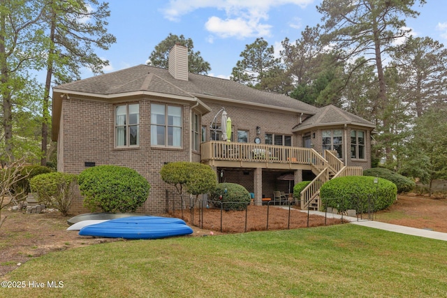 rear view of property with stairway, a lawn, a chimney, a deck, and brick siding
