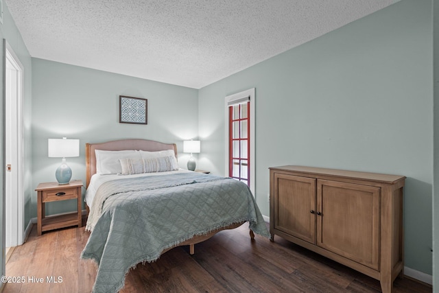 5 Pine Tree Rd Unit 211, Pinehurst, NC 28374 - bedroom featuring wood finished floors, a textured ceiling, and baseboards