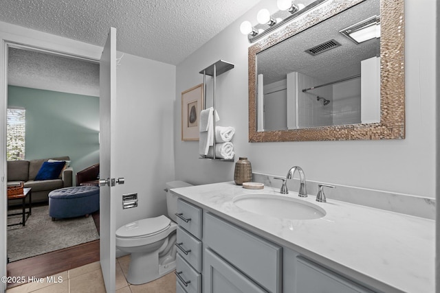 5 Pine Tree Rd Unit 211, Pinehurst, NC 28374 - bathroom featuring vanity, a textured ceiling, toilet, a shower, and tile patterned floors