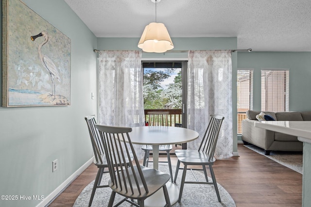 5 Pine Tree Rd Unit 211, Pinehurst, NC 28374 - dining area featuring a textured ceiling, wood finished floors, and baseboards