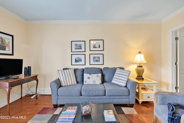 living area with crown molding, wood-type flooring, and baseboards