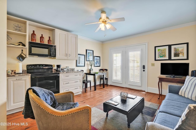 living room featuring crown molding, ceiling fan, baseboards, and light wood-style floors