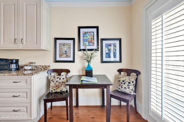 sitting room with wood finished floors, baseboards, and ornamental molding