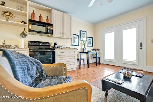 interior space featuring crown molding, ceiling fan, and light wood-type flooring