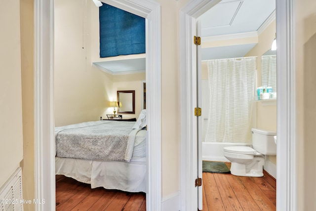 bedroom featuring hardwood / wood-style floors and ornamental molding
