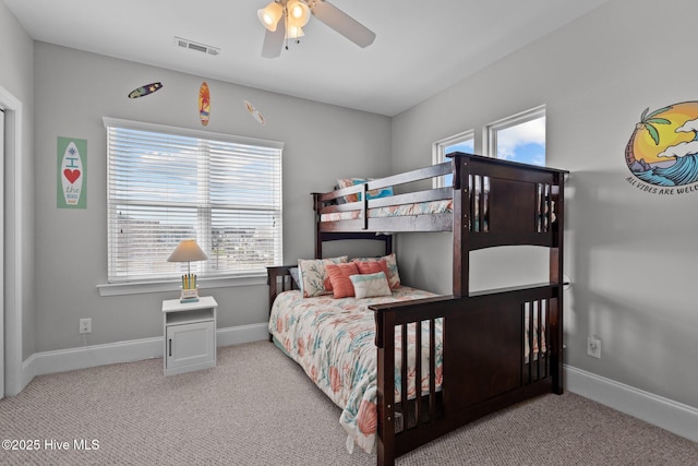carpeted bedroom featuring visible vents, a ceiling fan, and baseboards