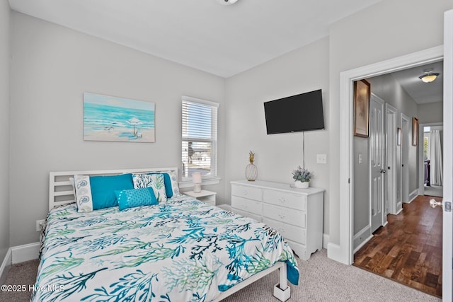 bedroom featuring carpet flooring and baseboards