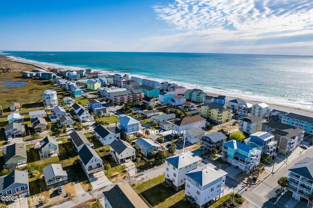 birds eye view of property featuring a view of the beach and a water view