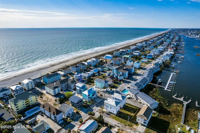 birds eye view of property featuring a view of the beach and a water view