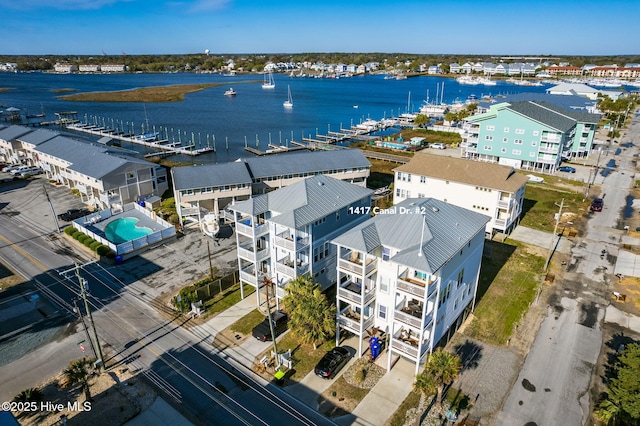 birds eye view of property featuring a beach view and a water view