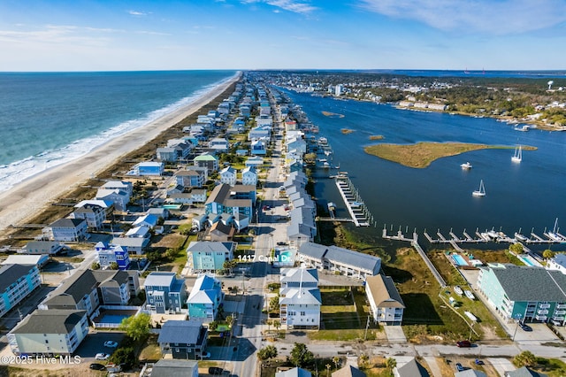birds eye view of property featuring a beach view and a water view
