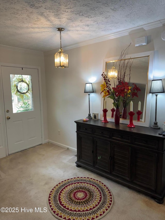 1735 W Pennsylvania Ave, Southern Pines, NC 28387 - entrance foyer featuring light carpet, a textured ceiling, a chandelier, crown molding, and baseboards
