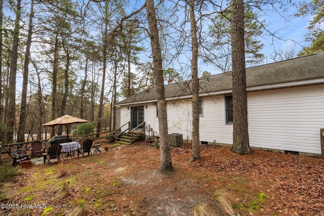 1 Vail Pl, Pinehurst, NC 28374 - rear view of house featuring central air condition unit, a shingled roof, and crawl space