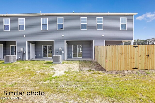 157 Loren Rd, Hubert, NC 28539 - rear view of house with a lawn, fence, and central AC