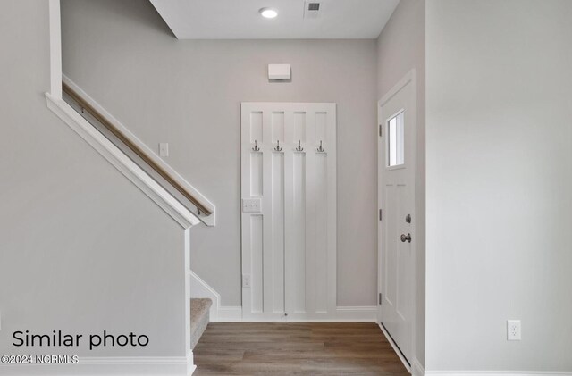 157 Loren Rd, Hubert, NC 28539 - entrance foyer with baseboards, visible vents, wood finished floors, and stairway