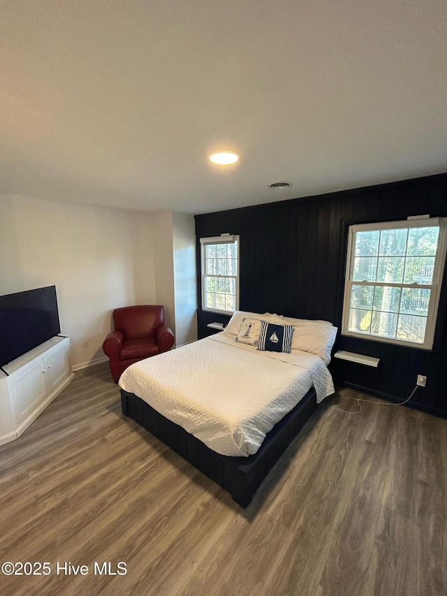 bedroom with recessed lighting, wood finished floors, and baseboards