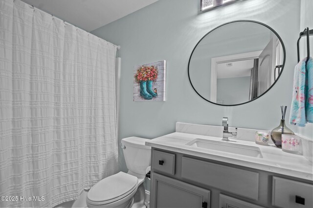 1317 Bowfin Ln Unit 2, Carolina Beach, NC 28428 - bathroom with toilet, vanity, and curtained shower