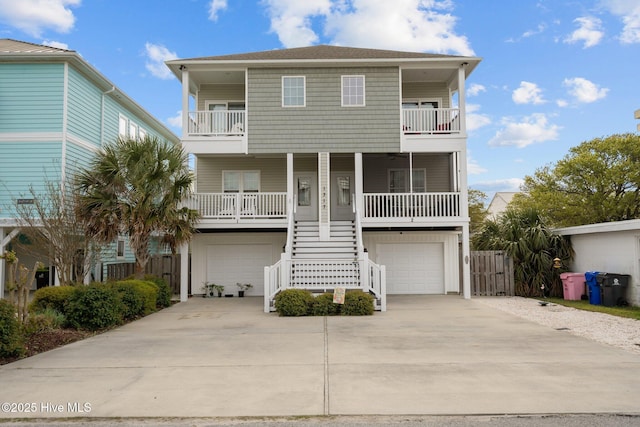 1317 Bowfin Ln Unit 2, Carolina Beach, NC 28428 - raised beach house featuring a porch, stairway, a balcony, and an attached garage