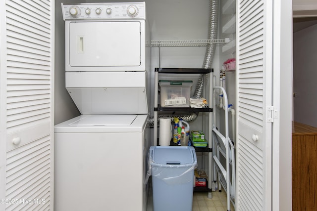 laundry area with laundry area, stacked washer and dryer, and tile patterned floors
