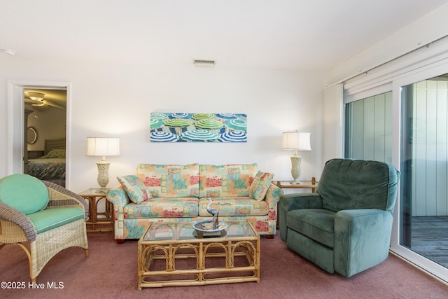 living area with visible vents and carpet floors