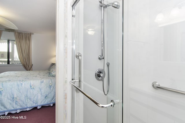 ensuite bathroom featuring a shower stall and ensuite bathroom