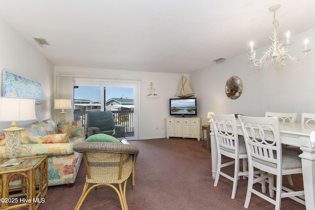 living area featuring carpet, a notable chandelier, and visible vents