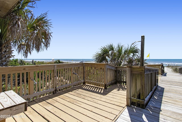 wooden terrace with a water view and a beach view