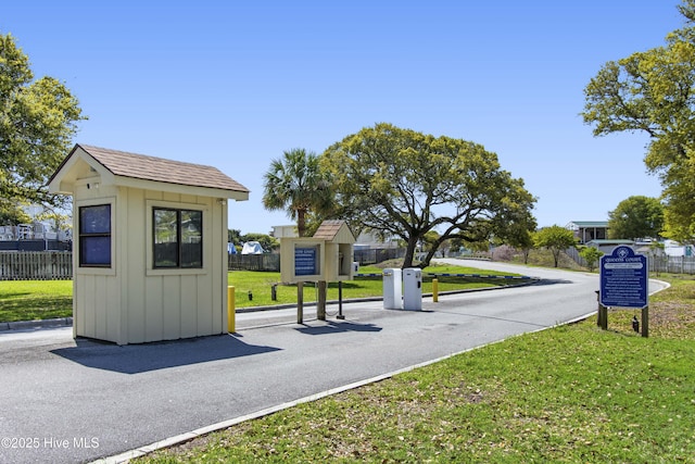 exterior space featuring fence and a lawn