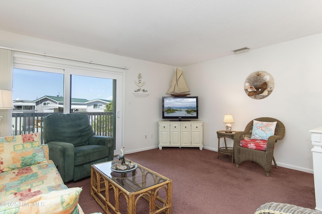 living area featuring dark carpet, baseboards, and visible vents