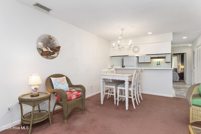 carpeted dining space with visible vents, baseboards, recessed lighting, and a chandelier