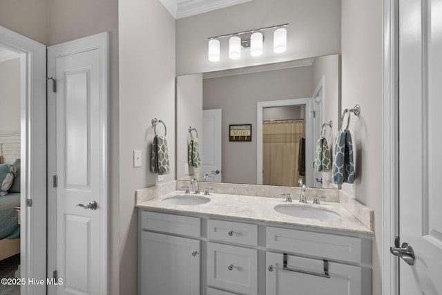ensuite bathroom with crown molding, double vanity, a sink, and ensuite bath