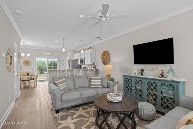 living room with recessed lighting, ornamental molding, light wood finished floors, baseboards, and a ceiling fan