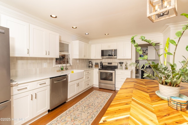 206 Robin Ln, Edenton, NC 27932 - kitchen with appliances with stainless steel finishes, a sink, white cabinets, backsplash, and recessed lighting