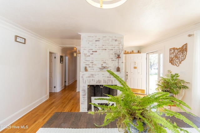 206 Robin Ln, Edenton, NC 27932 - living area featuring crown molding, wood finished floors, baseboards, and a brick fireplace
