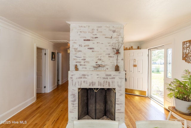 206 Robin Ln, Edenton, NC 27932 - living area with light wood-style floors, crown molding, a large fireplace, and baseboards