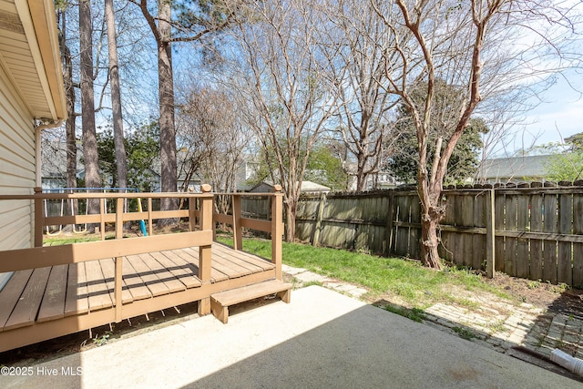 view of yard featuring a fenced backyard, a deck, and a patio