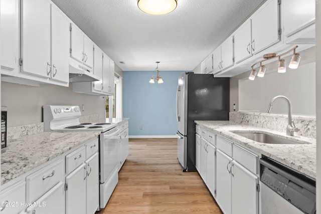 kitchen featuring under cabinet range hood, white cabinets, a sink, and appliances with stainless steel finishes