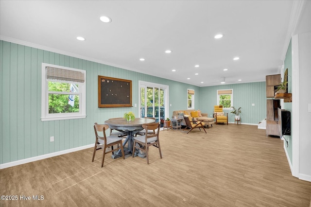 dining space featuring crown molding, baseboards, light wood-type flooring, and recessed lighting