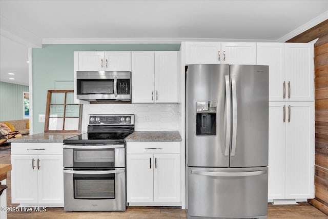 kitchen featuring white cabinetry, light stone countertops, and stainless steel appliances