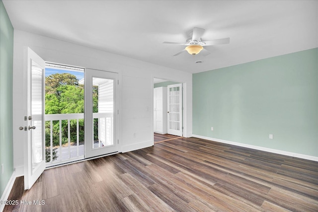 empty room with baseboards, a ceiling fan, and wood finished floors