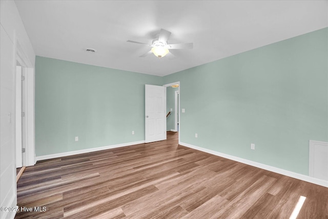 unfurnished bedroom featuring baseboards, ceiling fan, and wood finished floors