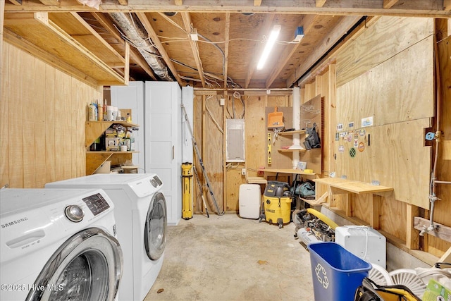 interior space featuring a workshop area, electric panel, and washer and clothes dryer