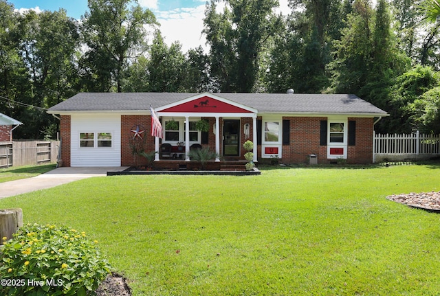 304 Sheffield Rd, Jacksonville, NC 28546 - single story home with a front lawn, fence, a porch, and brick siding