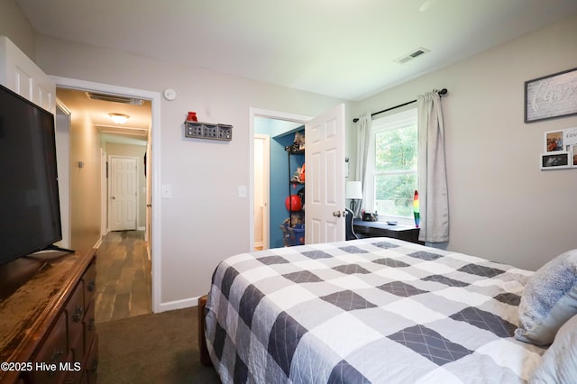 304 Sheffield Rd, Jacksonville, NC 28546 - bedroom featuring dark carpet, baseboards, and visible vents