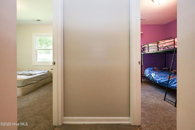 304 Sheffield Rd, Jacksonville, NC 28546 - hallway featuring baseboards, visible vents, and carpet floors