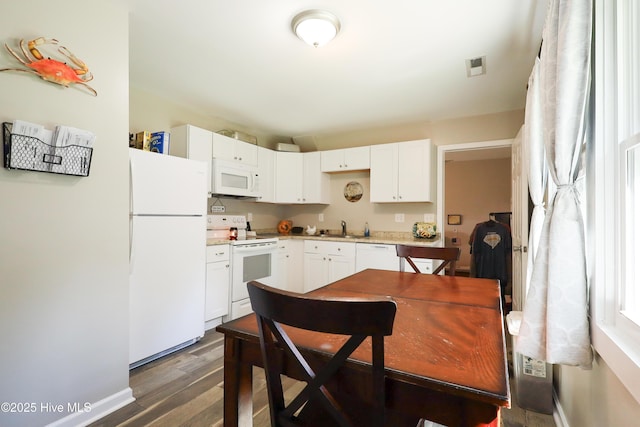 304 Sheffield Rd, Jacksonville, NC 28546 - kitchen with light countertops, visible vents, white appliances, a sink, and dark wood-style floors