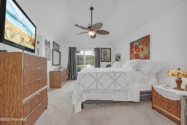 7001 Robert Ruark Dr SE, Southport, NC 28461 - bedroom featuring light colored carpet, vaulted ceiling, ceiling fan, and access to outside