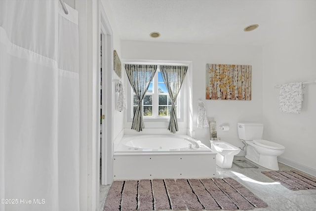7001 Robert Ruark Dr SE, Southport, NC 28461 - full bathroom with a jetted tub and a bidet