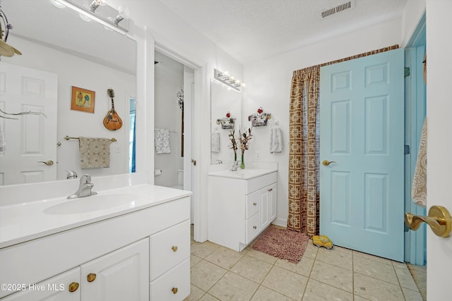 7001 Robert Ruark Dr SE, Southport, NC 28461 - bathroom featuring vanity, tile patterned flooring, and a textured ceiling