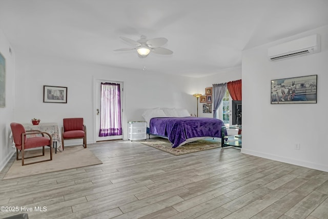7001 Robert Ruark Dr SE, Southport, NC 28461 - bedroom with an AC wall unit, light wood finished floors, and a ceiling fan